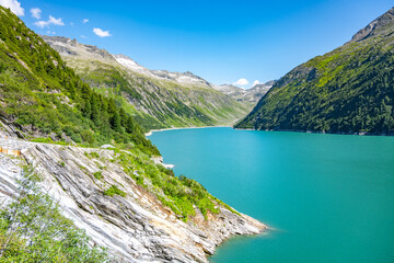 Obraz na płótnie Canvas Beautiful alpine walley with azure blue water dam