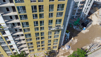 Obraz premium Building external wall thermal insulation with mineral wool. Exterior passive house wall heat insulation with mineral wool. Insulation the facade of commercial building. Energy efficiency