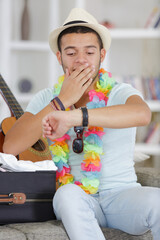 portrait of young handsome checking his watch