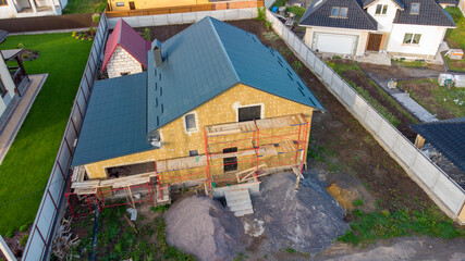 thermal insulation of a building on a construction site with mineral wool sheets.