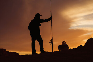 Silhouette of Fisherman at Sunset - 468454800