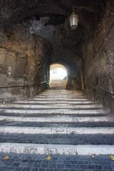 staircase leading from the tunnel towards the light