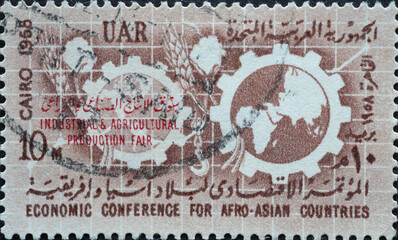 Egypt - Circa 1958: A post stamp printed in Egypt showing Maps and Cogwheels. Economic Conference...