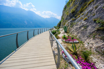 "Ciclopista del Garda" - Bicycle road and foot path over Garda lake with beautiful landscape scenery at Limone Sul Garda - travel destination in Brescia, Italy