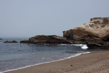 Rough central California coast with cliffs and rocks on a summer morning