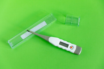 electronic thermometer without logo on a green background
