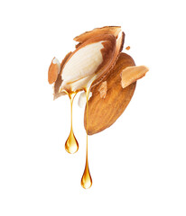 Stretched drops of oil dripping from crushed almonds close-up on a white background