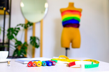 a colorful dress on a mannequin for pride parade in dressmaking showroom