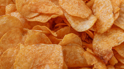 Fototapeta premium Potato chips or crisps . Close-up of potato chips or crisps. Food background.