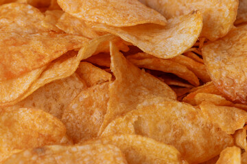 Potato chips or crisps . Close-up of potato chips or crisps. Food background.