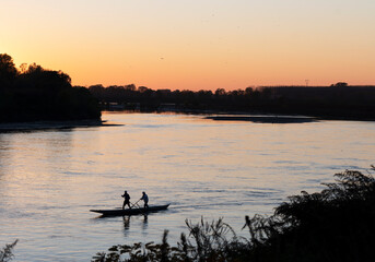 Fototapeta na wymiar Boats on the Po river at sunset, Autumn, Cremona