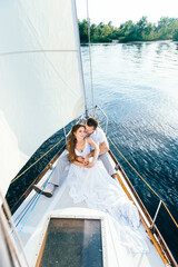 young couple guy and girl on a sailing yacht