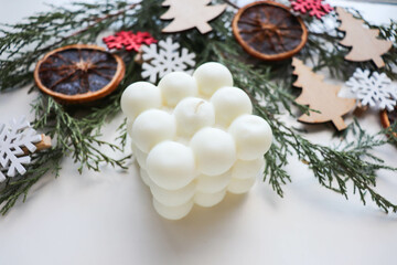 Natural handmade soy candle and fir branches with Christmas balls. gift concept 