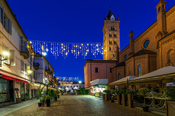 Fototapeta premium San Lorenzo cathedral and illuminated street in Alba, Italy