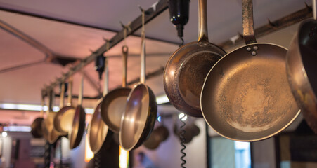 saucepans hanging from a rack in the kitchen.