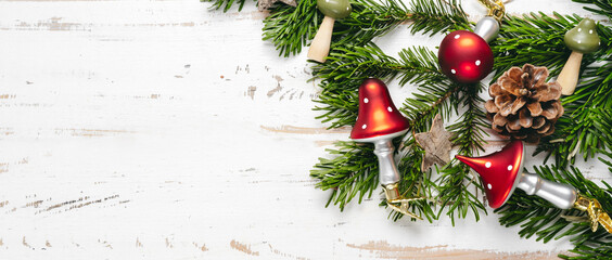 Top view of Christmas decorations in mushrooms shape on white wooden background