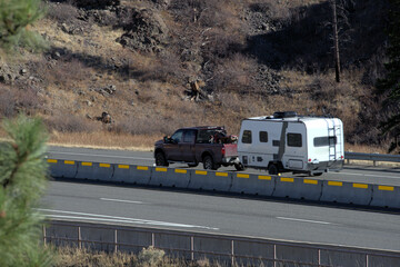 Travel: For vacation or a hunting trip, this vehicle, with off-roader ATV in the back and pulling a travel trailer, is ready for anything.