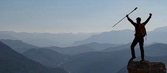 silhouette of a person on a mountain