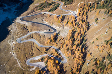 Curvy road up to Passo Gardena near Corvara in the italian alps during autumn