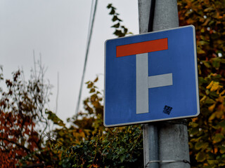 Close-up shot of a blue square dead end street road sign attached on a pole
