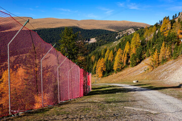 Protection fence of a ski slope on Seceda Mountain in late autumn, Doomites, Italy, Europe