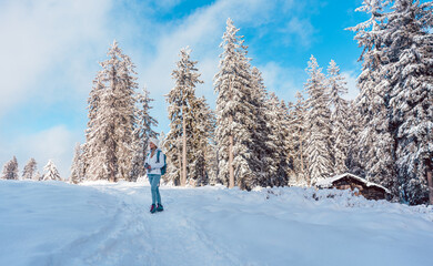 Hiking in the snow on a mountain slope in winter under a blue sky