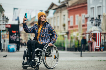 Woman with disability taking a selfie with her smartphone while out in the city