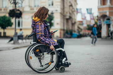 Woman with disability using a smartphone while out in the city