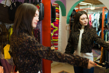 Caucasian woman trying on clothes