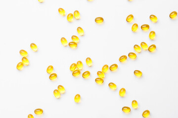Many vitamin A capsules isolated on white background, closeup