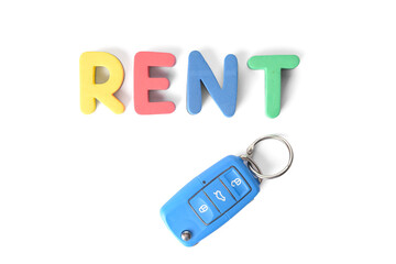 Key from car and word RENT on white background