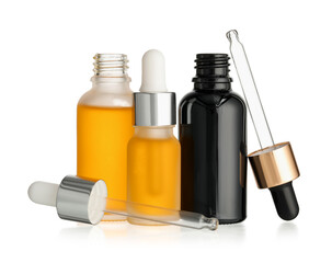 Different bottles of essential oil on white background