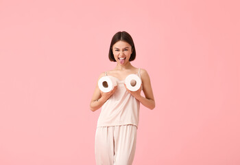 Funny young woman with toilet paper on color background