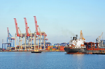 Tugboat assisting bulk cargo ship