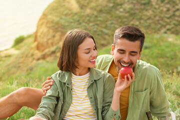 Fototapeta premium Happy young couple having romantic picnic in mountains
