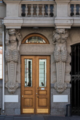 Gate decorating with figures of atlant and caryatid in Saint Petersburg, Russia