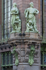 Statues of Science and Industry in the facade of Elisseeff Emporium in St. Petersburg, Russia