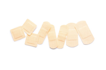 Many medical plasters on white background