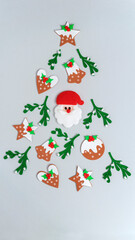 abstract christmas background with gingerbread stars and bells stickers, mistletoe felt sprigs and santa claus face