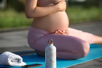 Bottle of water on mat in park, closeup