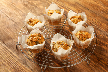 Grid with tasty spinach muffins on wooden background