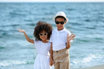 African-American brother and sister on sea beach