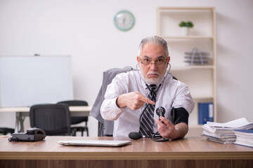 Aged male employee suffering at workplace