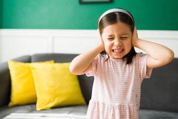 Sad kid listening to her parents fighting