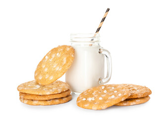 Tasty cookies with chocolate chips and mason jar of milk on white background