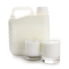 Gallon bottle and glasses of milk on white background