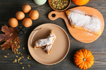 Composition with delicious pumpkin strudel on wooden table