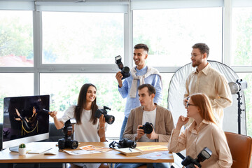 Professional photographer teaching young people in studio