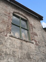 Fototapeta na wymiar Glass window of an old brick fort in the Caribbean
