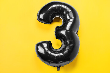 Balloon in shape of figure 3 on yellow background
